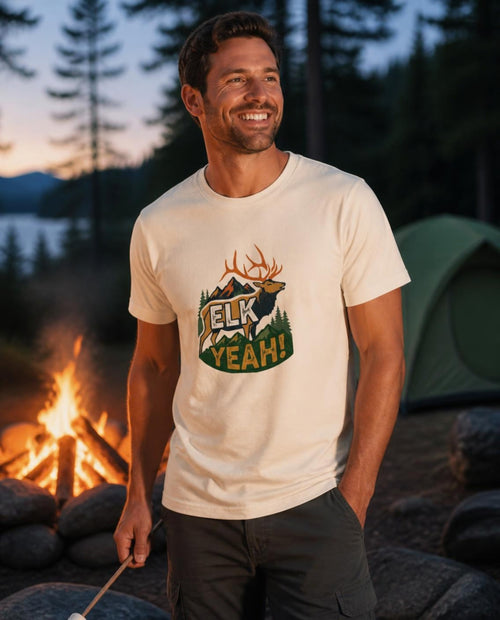 Man wearing a vintage white Elk Yeah! t-shirt at a campfire