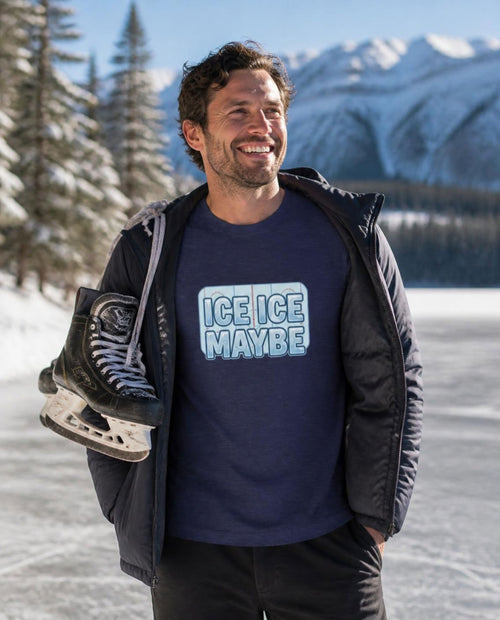 Man wearing a navy Ice Ice Maybe t-shirt beside a frozen mountain lake
