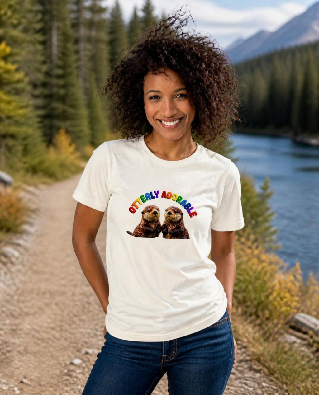 Woman wearing a vintage white Otterly Adorable t-shirt on a riverside forest trail