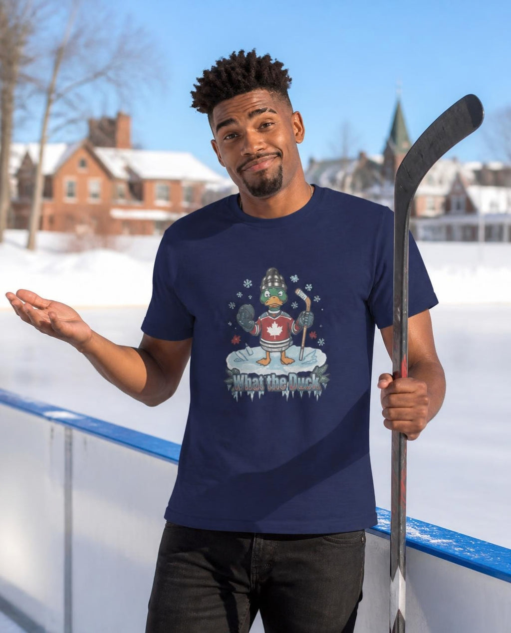 Man wearing a navy What the Duck? hockey t-shirt at an outdoor ice rink