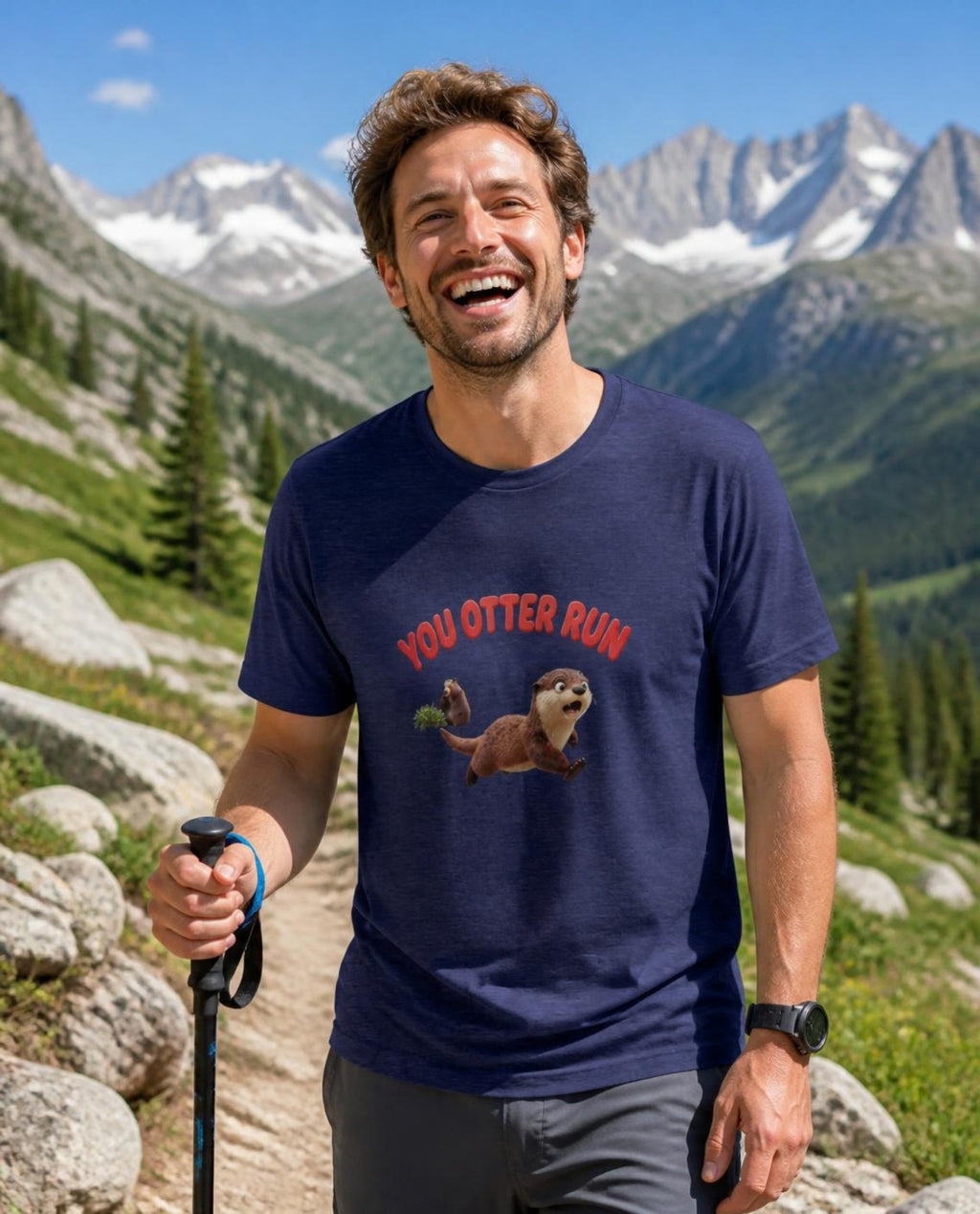 Man wearing a navy You Otter Run t-shirt on an alpine hiking trail in the Rockies